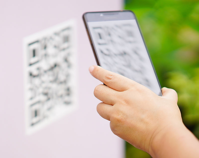 hand scanning qr code with smartphone